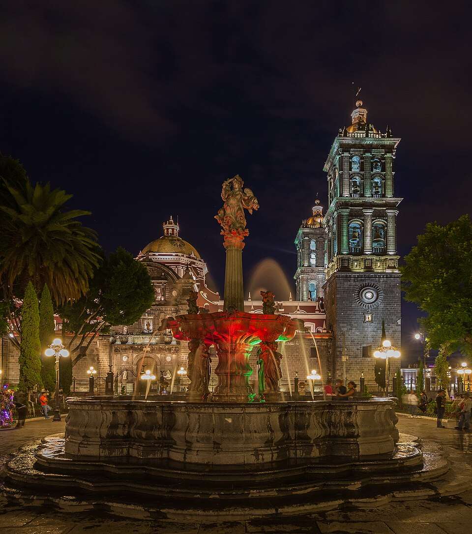 Puebla's cathedral and the zócalo fountain at night